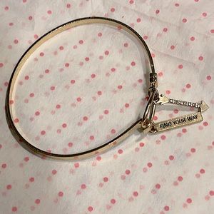 BCBGeneration “find your way” gold bangle.